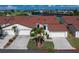 Beautiful condo featuring a red tile roof, white exterior, and well-manicured landscaping at 1640 Atares # 23, Punta Gorda, FL 33950