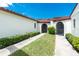 Home featuring a tile roof, arched doorways, and manicured hedges at 1640 Atares # 23, Punta Gorda, FL 33950