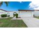 Charming home exterior features a well-manicured lawn and attached two-car garage at 1640 Atares # 23, Punta Gorda, FL 33950