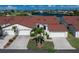 Beautiful condo featuring a red tile roof, white exterior, and well-manicured landscaping at 1640 Atares # 23, Punta Gorda, FL 33950