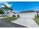 Street view of homes with tile roofs, driveways, and manicured lawns at 1640 Atares # 23, Punta Gorda, FL 33950