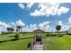Picturesque gazebo nestled in a lush landscape with a tranquil pond and palm trees at 1640 Atares # 23, Punta Gorda, FL 33950