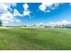 Expansive golf course view featuring a manicured green, water feature, and blue sky at 1640 Atares # 23, Punta Gorda, FL 33950