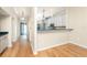 Hallway with hardwood floors and view of the kitchen and front door at 1640 Atares # 23, Punta Gorda, FL 33950