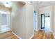 Hallway leading to a full bath, with wood floors throughout at 1640 Atares # 23, Punta Gorda, FL 33950