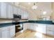 Bright kitchen with stainless steel appliances, cabinets, and dark countertops at 1640 Atares # 23, Punta Gorda, FL 33950