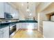 Bright kitchen with stainless steel appliances and green counters at 1640 Atares # 23, Punta Gorda, FL 33950
