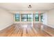 Spacious living room with hardwood floors, large windows, and natural light at 1640 Atares # 23, Punta Gorda, FL 33950