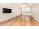 Bright living room with hardwood floors, tv, and a doorway to the kitchen at 1640 Atares # 23, Punta Gorda, FL 33950