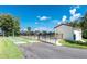 Community pool with lounge area next to a shuffleboard court on a sunny day at 1640 Atares # 23, Punta Gorda, FL 33950