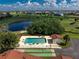 Community pool with lounge chairs, shuffleboard courts, and green golf course views at 1640 Atares # 23, Punta Gorda, FL 33950