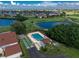 Community pool and shuffleboard courts sit near lush golf course and blue lake at 1640 Atares # 23, Punta Gorda, FL 33950