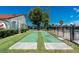 Shuffleboard court with lush landscaping and a view of the community pool and lake at 1640 Atares # 23, Punta Gorda, FL 33950