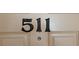 Close-up of apartment number 511 on a neutral colored condo door at 1760 Gulf Blvd # 511, Englewood, FL 34223