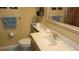 Bathroom featuring a white countertop, framed mirror, and decorative seashell accents at 1760 Gulf Blvd # 511, Englewood, FL 34223