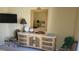 Bedroom featuring a wicker dresser with marble top, lamps, tv and tropical decor at 1760 Gulf Blvd # 511, Englewood, FL 34223