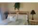 Cozy bedroom features a wicker headboard, floral bedding, and bright natural light at 1760 Gulf Blvd # 511, Englewood, FL 34223