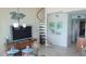 Dining area adjacent to a spiral staircase, featuring a glass table and stylish decor at 1760 Gulf Blvd # 511, Englewood, FL 34223