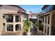 Exterior view of community featuring Mediterranean style architecture and lush palm trees at 1760 Gulf Blvd # 511, Englewood, FL 34223