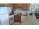 Well-equipped kitchen with modern appliances, tile backsplash, and granite countertops at 1760 Gulf Blvd # 511, Englewood, FL 34223