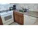 Efficient kitchen layout with modern appliances and ample counter space for cooking and meal preparation at 1760 Gulf Blvd # 511, Englewood, FL 34223