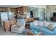 Cozy living room featuring comfortable seating and kitchen view with a spiral staircase in the background at 1760 Gulf Blvd # 511, Englewood, FL 34223