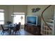 Living area with dining table, staircase, and entertainment center at 1760 Gulf Blvd # 511, Englewood, FL 34223