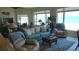 Bright living room with comfortable seating and a stunning ocean view from the large windows at 1760 Gulf Blvd # 511, Englewood, FL 34223