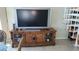 A wooden console table with the TV adjacent to a spiral staircase at 1760 Gulf Blvd # 511, Englewood, FL 34223