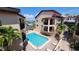Inviting community pool surrounded by lush palm trees and well-maintained landscaping at 1760 Gulf Blvd # 511, Englewood, FL 34223