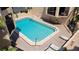Community swimming pool with brick patio and deck chairs at 1760 Gulf Blvd # 511, Englewood, FL 34223