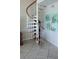 Light and airy entryway showcasing a modern spiral staircase with wooden steps at 1760 Gulf Blvd # 511, Englewood, FL 34223