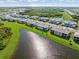 Aerial view highlights Wellen Park homes nestled alongside a serene lake at 17605 Boracay Ct # 201, Venice, FL 34293