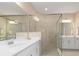 Modern bathroom featuring a glass-enclosed shower, dual vanities, and contemporary lighting at 17605 Boracay Ct # 201, Venice, FL 34293