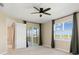 Cozy bedroom with a large window, patio access, and views of the surrounding lake at 17605 Boracay Ct # 201, Venice, FL 34293