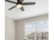 Bright bedroom with a ceiling fan, large window, and view of rooftops at 17605 Boracay Ct # 201, Venice, FL 34293