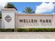 Wellen Park entrance sign with manicured landscaping and a clear blue sky at 17605 Boracay Ct # 201, Venice, FL 34293