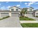 Attractive townhome exterior with a paver driveway and well-maintained landscaping at 17605 Boracay Ct # 201, Venice, FL 34293