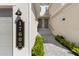 Welcoming exterior with covered walkway and front door entry, featuring well-maintained landscaping and address display at 17605 Boracay Ct # 201, Venice, FL 34293