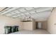Well-lit two car garage with overhead storage racks at 17605 Boracay Ct # 201, Venice, FL 34293