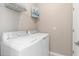 Efficient laundry room featuring a modern washer and dryer set with wire shelving at 17605 Boracay Ct # 201, Venice, FL 34293