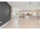 Open-concept living area with a kitchen featuring stainless steel appliances, a large island, and a decorative wall at 17605 Boracay Ct # 201, Venice, FL 34293