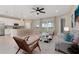 Bright, open-concept living area with a modern kitchen, stylish furniture, and seamless access to the outdoors at 17605 Boracay Ct # 201, Venice, FL 34293