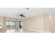 Spacious living room with neutral tones, tile flooring, sliding glass doors leading to a screened lanai with views at 17605 Boracay Ct # 201, Venice, FL 34293