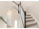 Carpeted staircase with dark wood accents and white railings, leading to the upper level of the home at 17605 Boracay Ct # 201, Venice, FL 34293