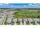 An aerial view of houses in a beautiful neighborhood with lush greenery and scenic pond in the distance at 17921 Grand Prosperity Dr, Venice, FL 34293