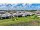An aerial view of backyards of houses in a beautiful neighborhood with well-maintained lawn and lush greenery at 17921 Grand Prosperity Dr, Venice, FL 34293