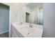 Bathroom featuring a double vanity with matching framed mirror, window, and shower with curtain at 17921 Grand Prosperity Dr, Venice, FL 34293