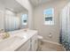 Bathroom featuring a double vanity with matching framed mirror, window, and shower with curtain at 17921 Grand Prosperity Dr, Venice, FL 34293