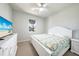 Bright bedroom with carpet, ceiling fan, queen bed, and dresser at 17921 Grand Prosperity Dr, Venice, FL 34293